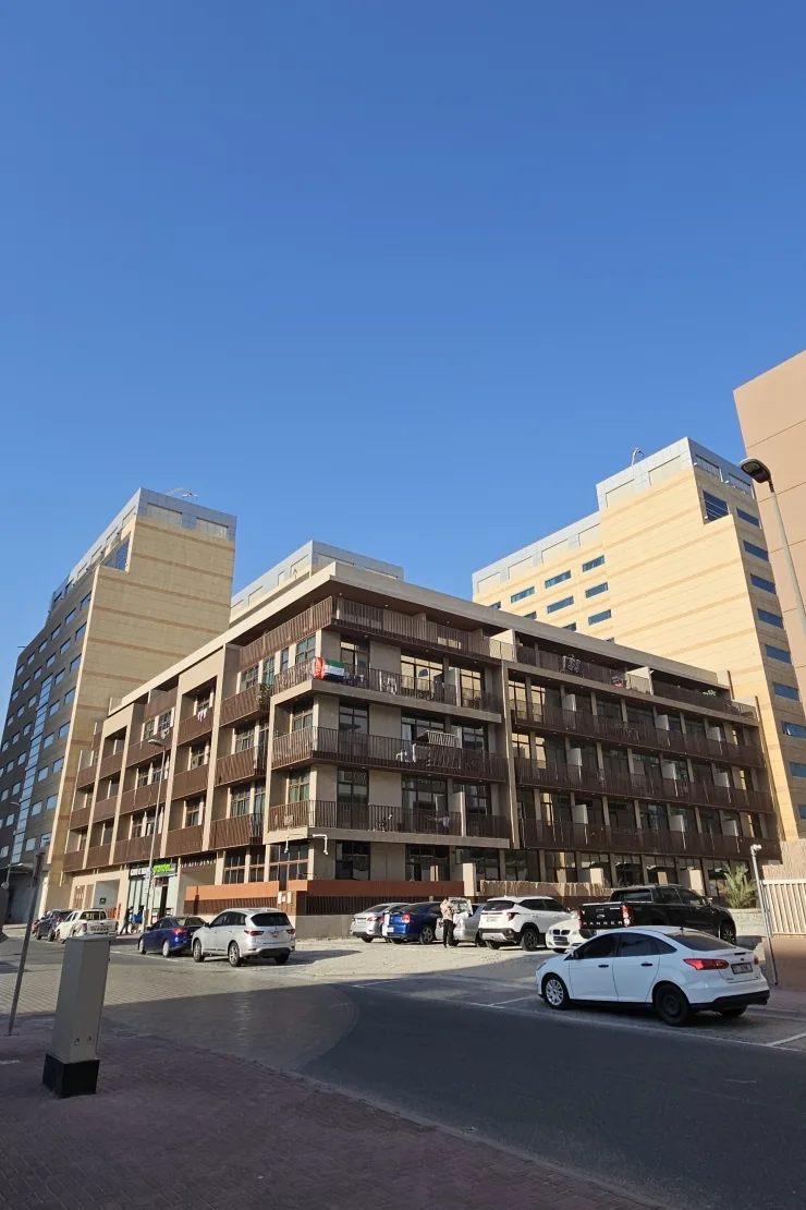 Completed low-rise building with balconies, street view