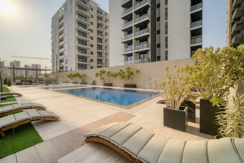 Podium-level pool with sun loungers