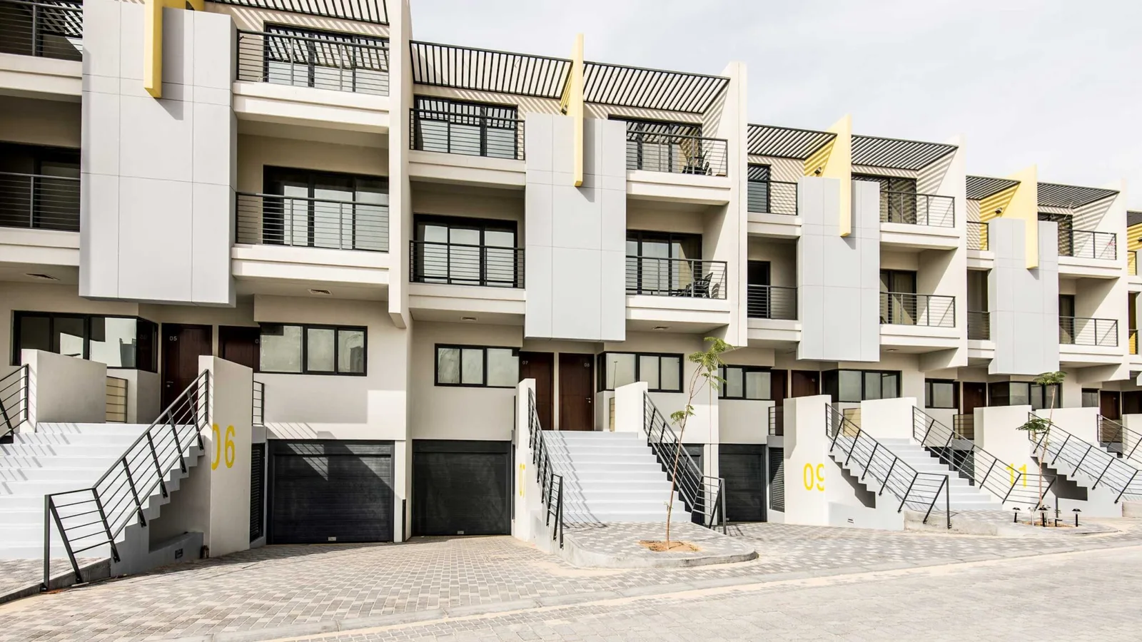 Townhouse fronts with staircases and garages