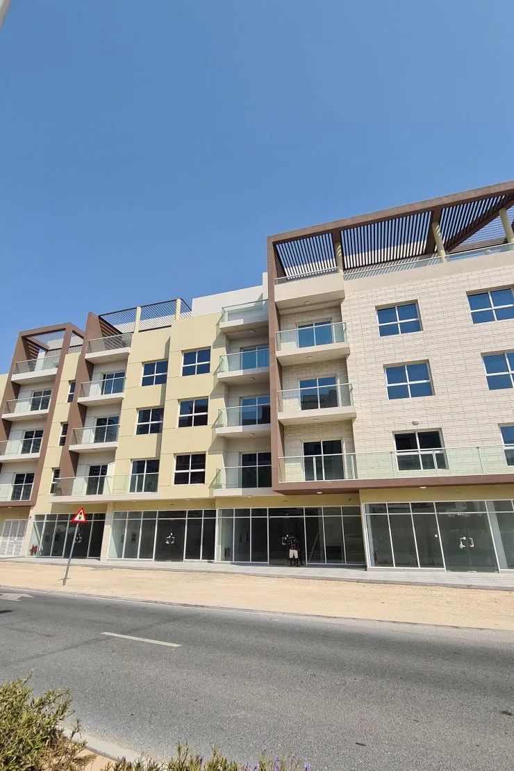 Street-facing facade with ground-floor retail and balconies