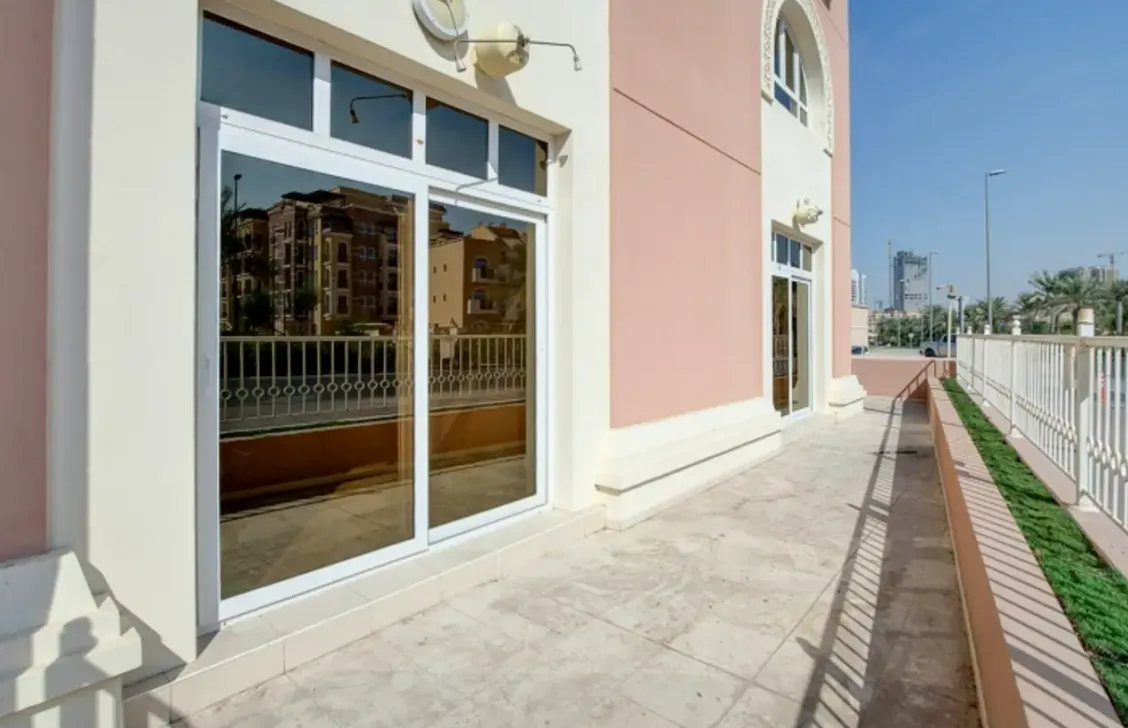 Ground-floor terrace with matching pink and cream facade