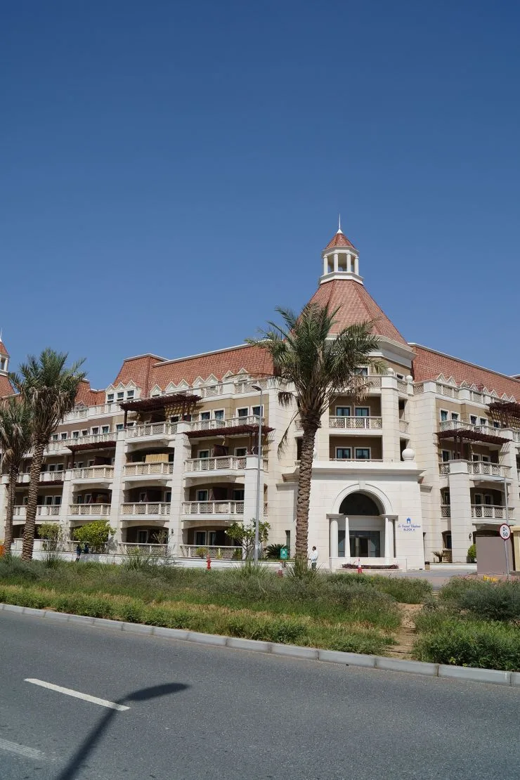 Le Grand Chateau Block A facade with turret and palms