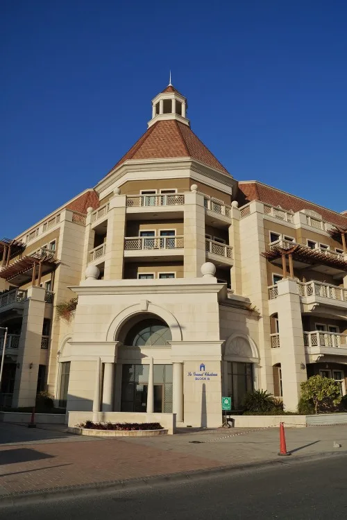 Corner entrance with turret, signed Le Grand Chateau Block B