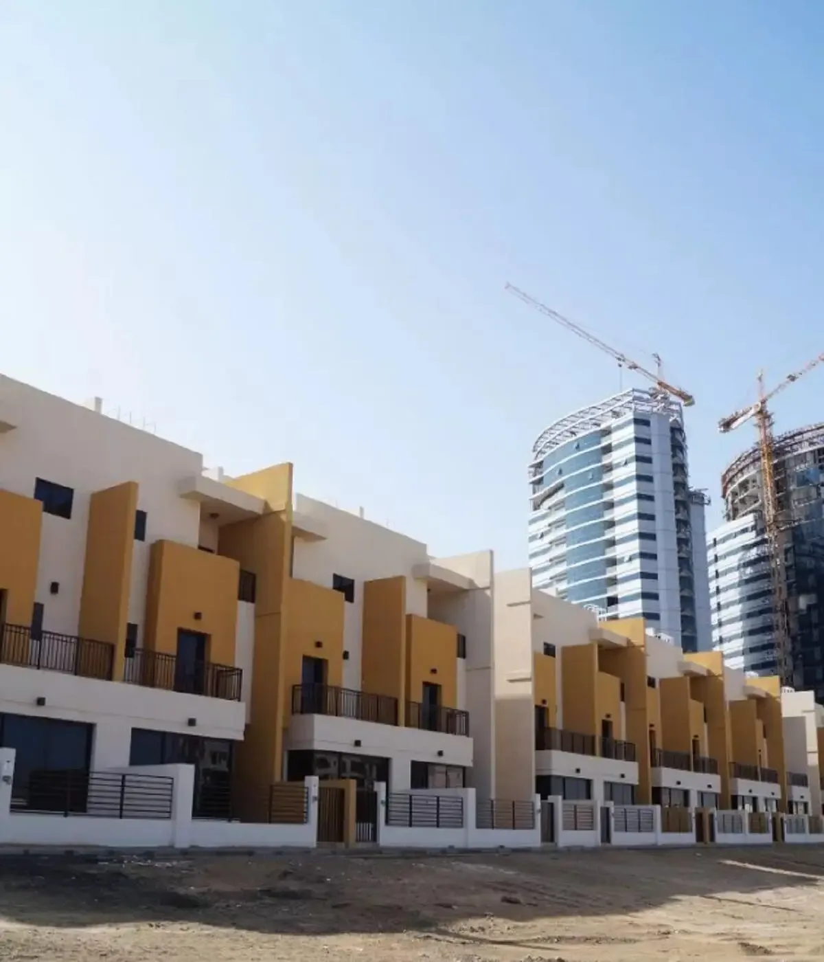 Townhouse row with white and mustard facade