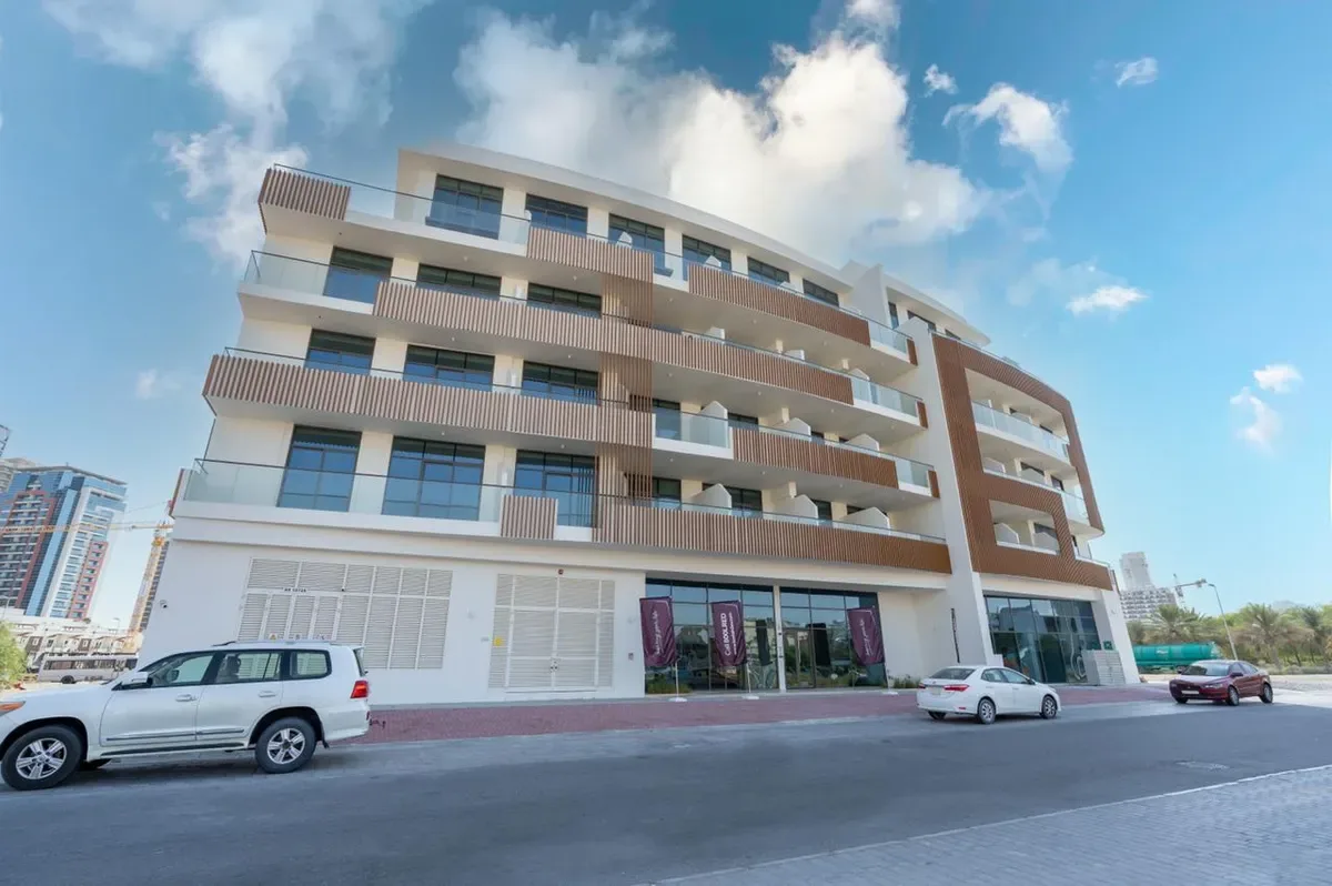 Full facade from street, timber fins and balconies