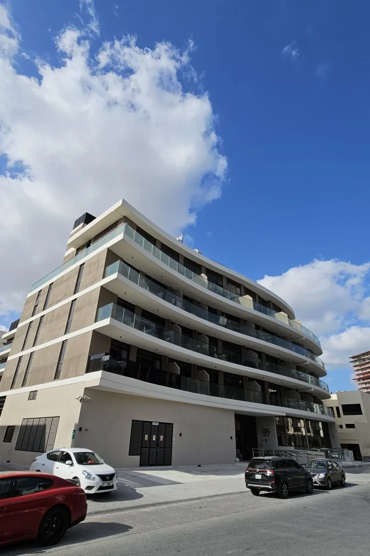 Completed curved-terrace building seen from the street