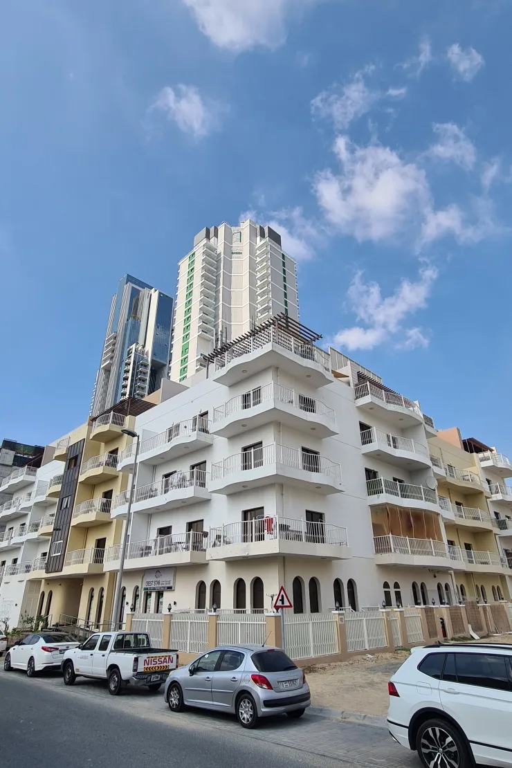 Cream and white low-rise block with curved balconies