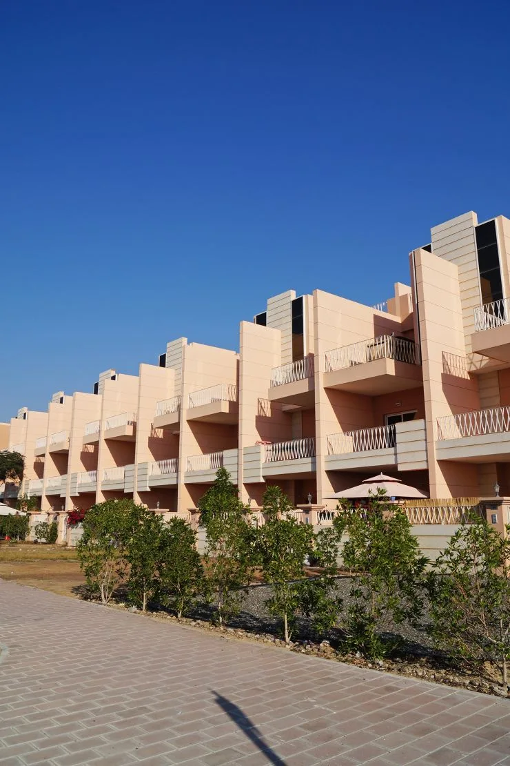 Stepped peach townhouse facades with balconies