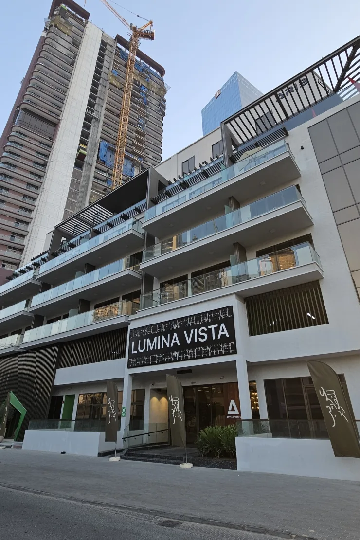 Entrance and balconies under Lumina Vista sign