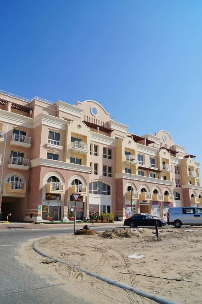 Street-level facade with arched windows and balconies