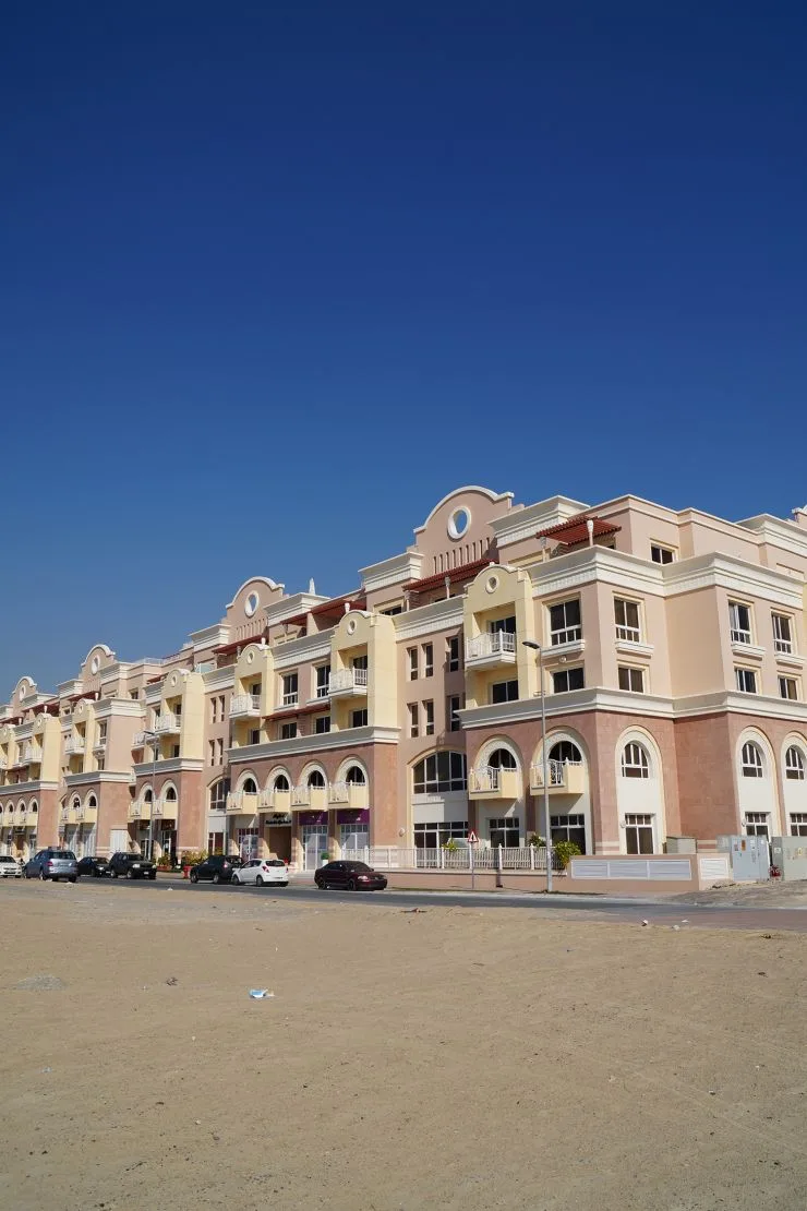 Long Maple block facade across open sand