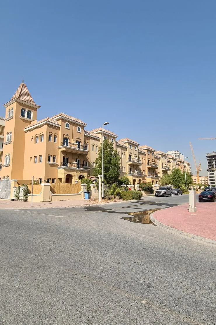 Row of Mediterranean townhouse-style blocks with corner tower
