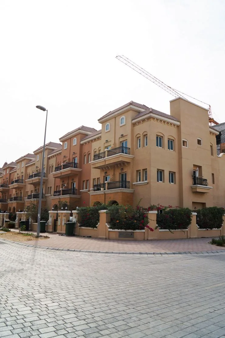 Corner of terracotta low-rise blocks with balconies