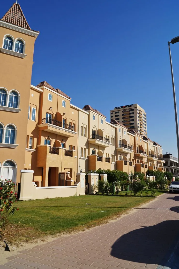 Townhouse row along lawn and pavement