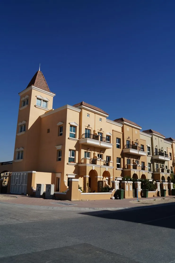 Ochre Mediterranean block with corner tower and tiled roof