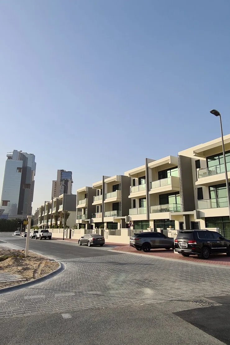 Street view of terraced villa row, matching facade