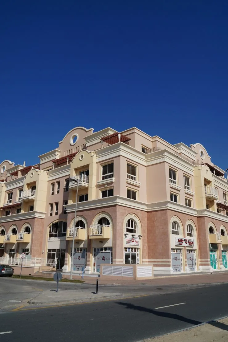 Pink Mediterranean-style corner building from street