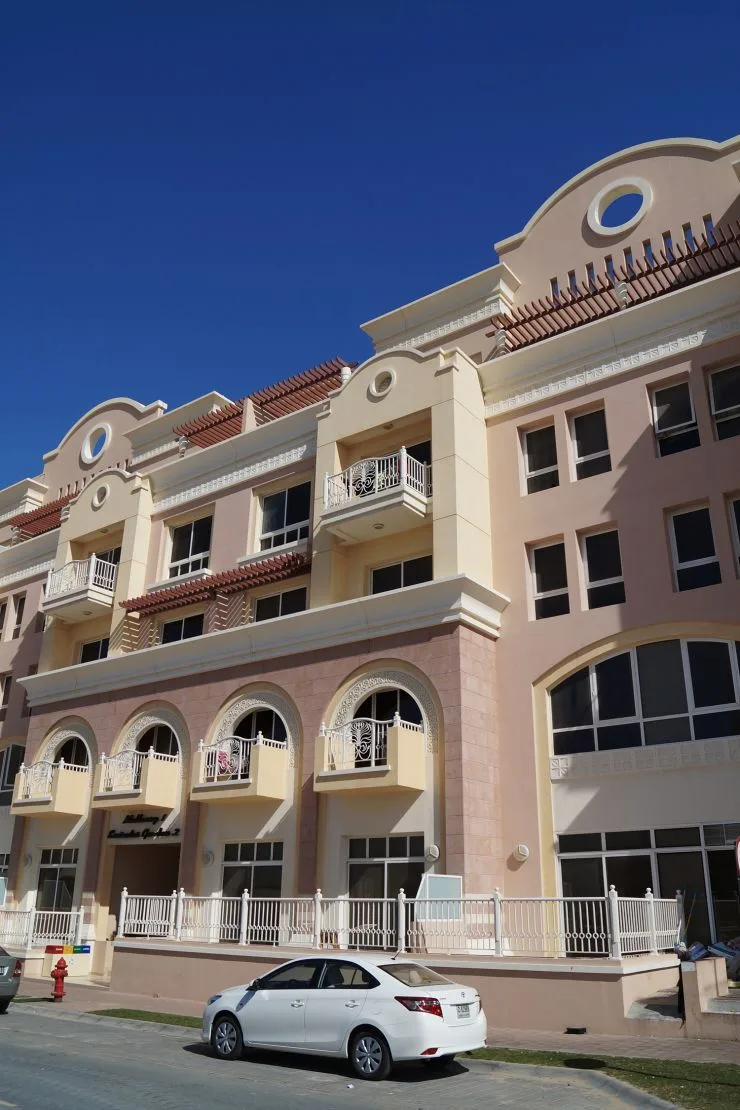 Pink and cream Mulberry 2 facade with arched balconies