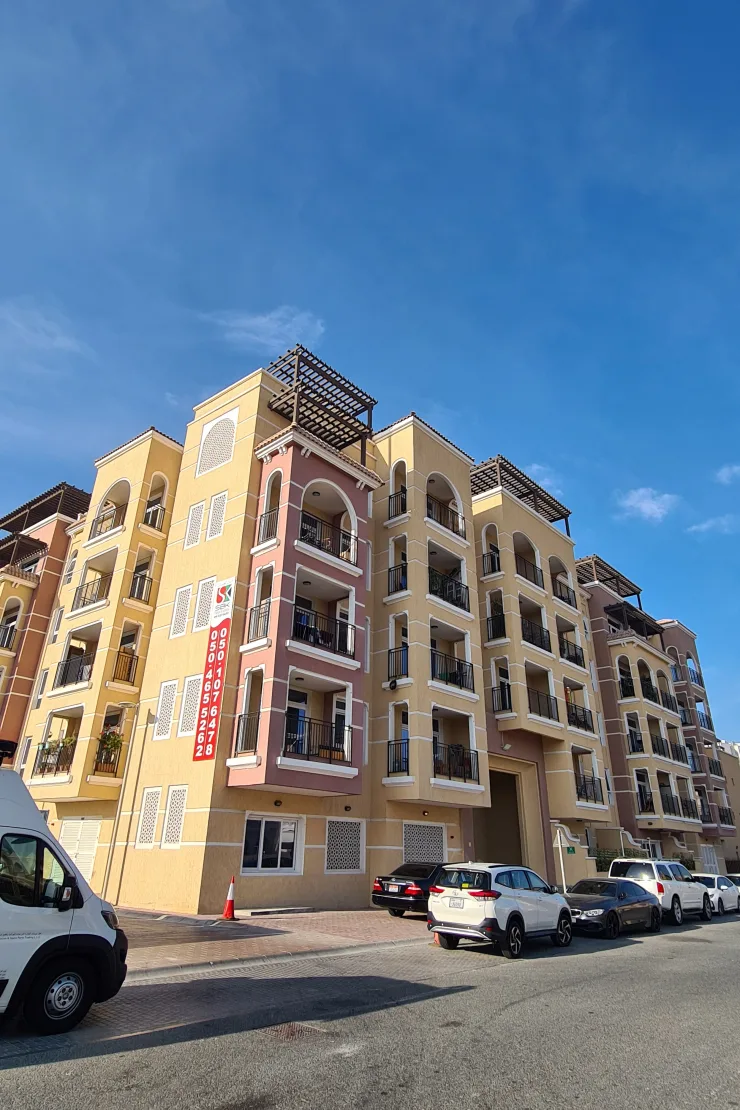 Corner view of Novem 2 with pink and yellow facade