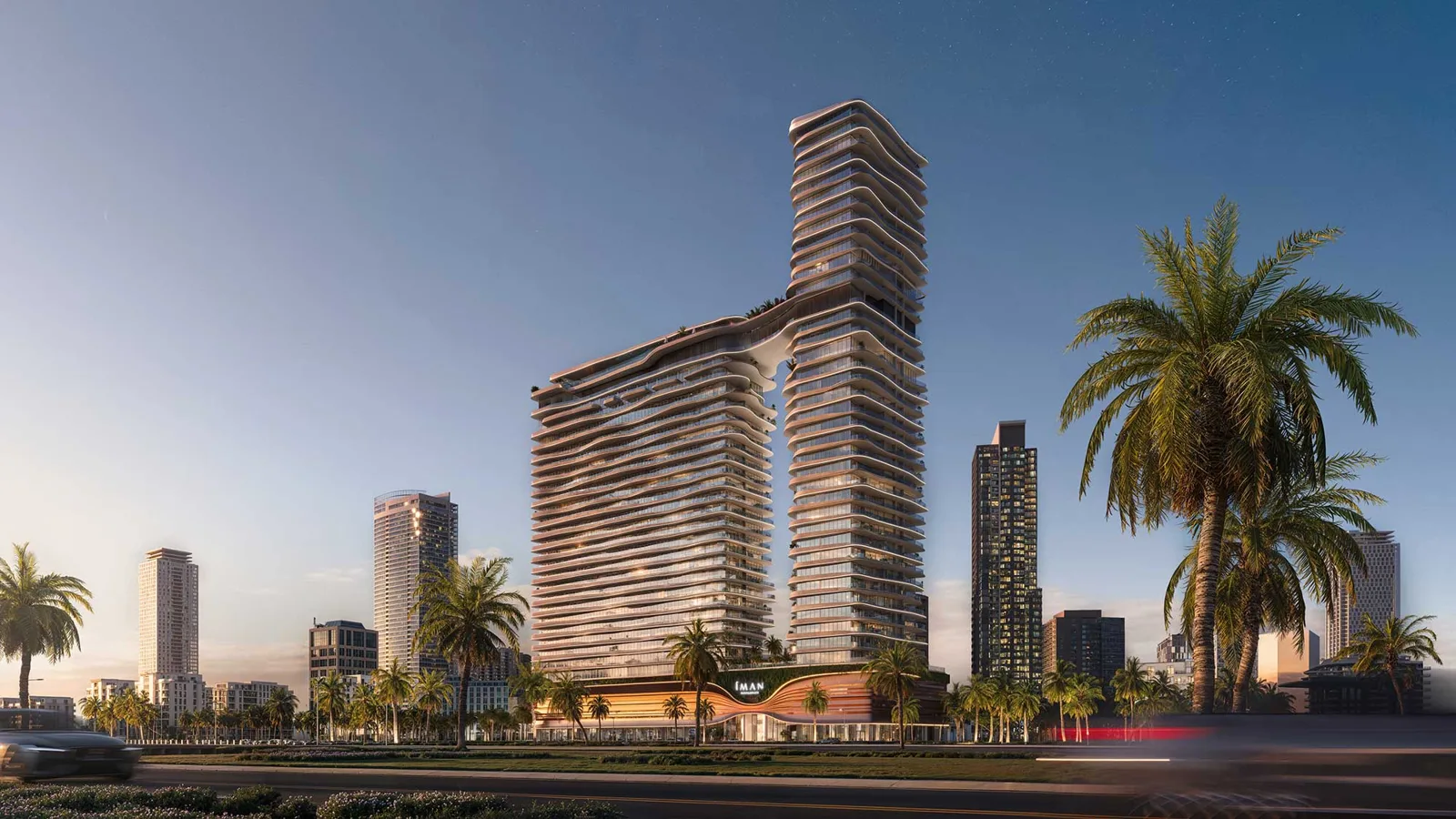 Full tower with curved balconies and podium at dusk
