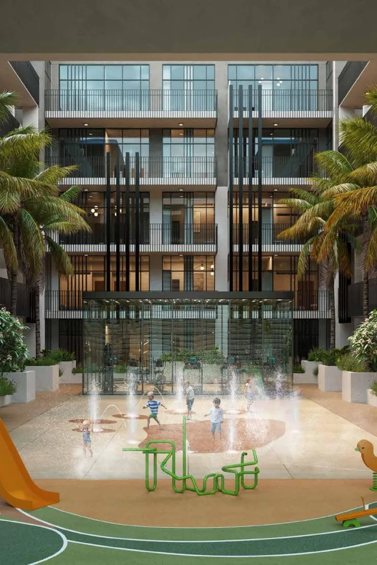 Courtyard splash pad and play area beneath facade