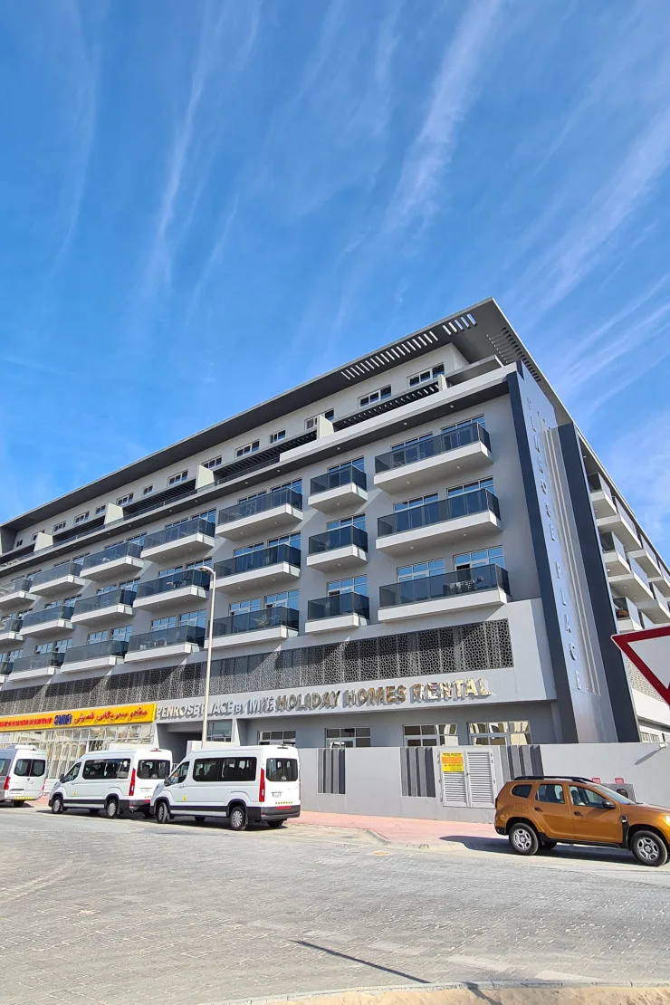 Completed facade with balconies and ground-floor signage