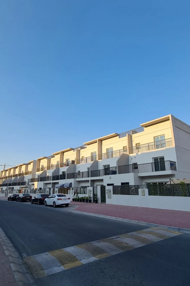 Row of white and beige townhouses from street