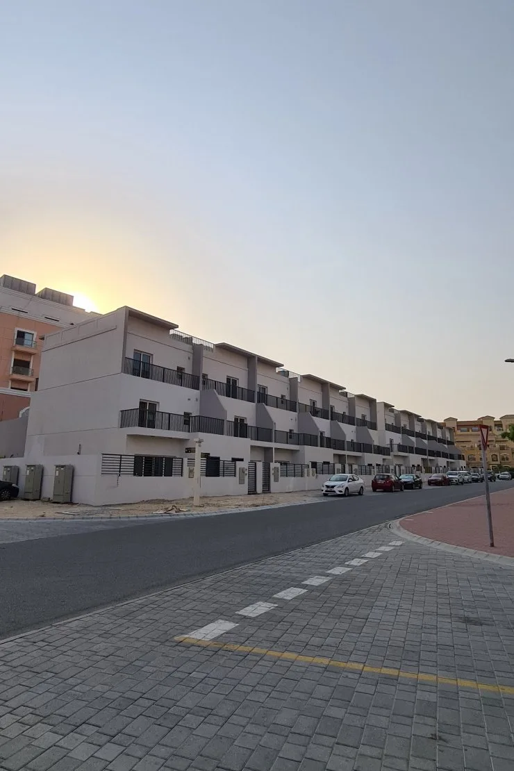 Townhouse row at dusk with balconies
