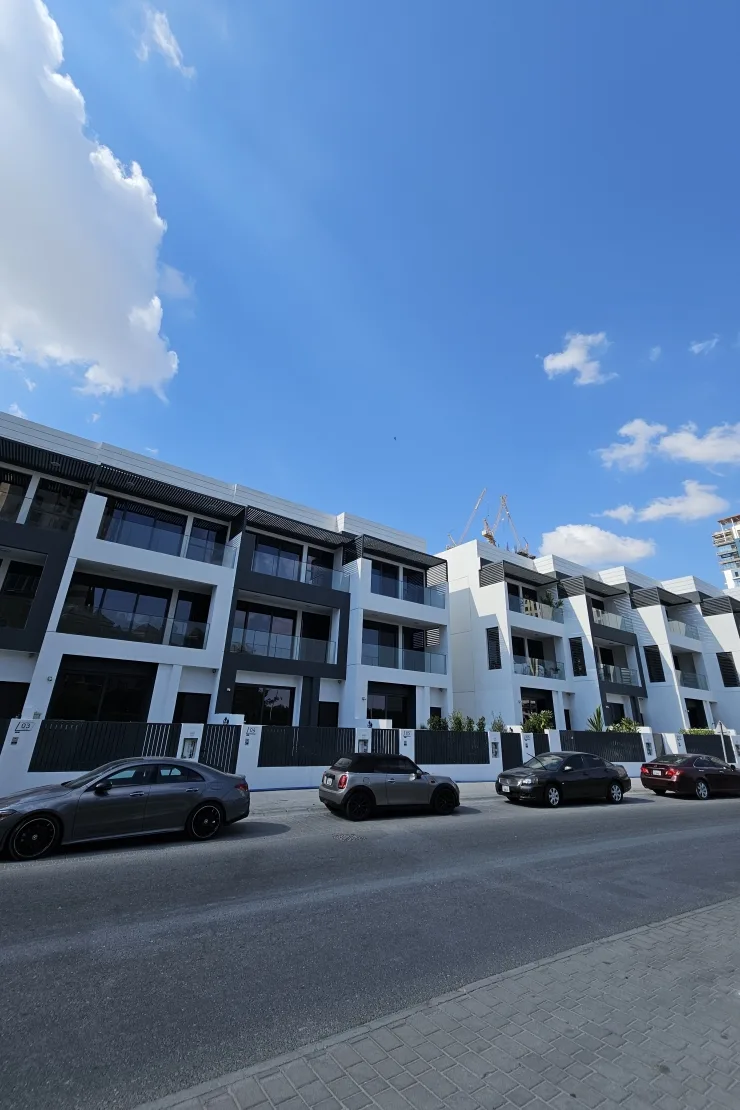 Street view of white and charcoal townhouse blocks
