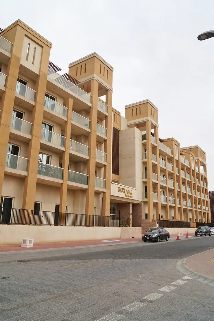 Sandstone towers with Roxana Residences signage, street view
