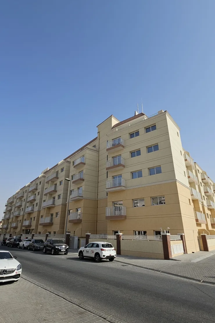 Corner of beige residential block with balconies