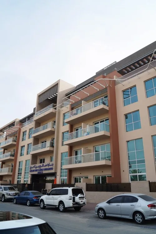 Street-side facade with balconies and entrance signage