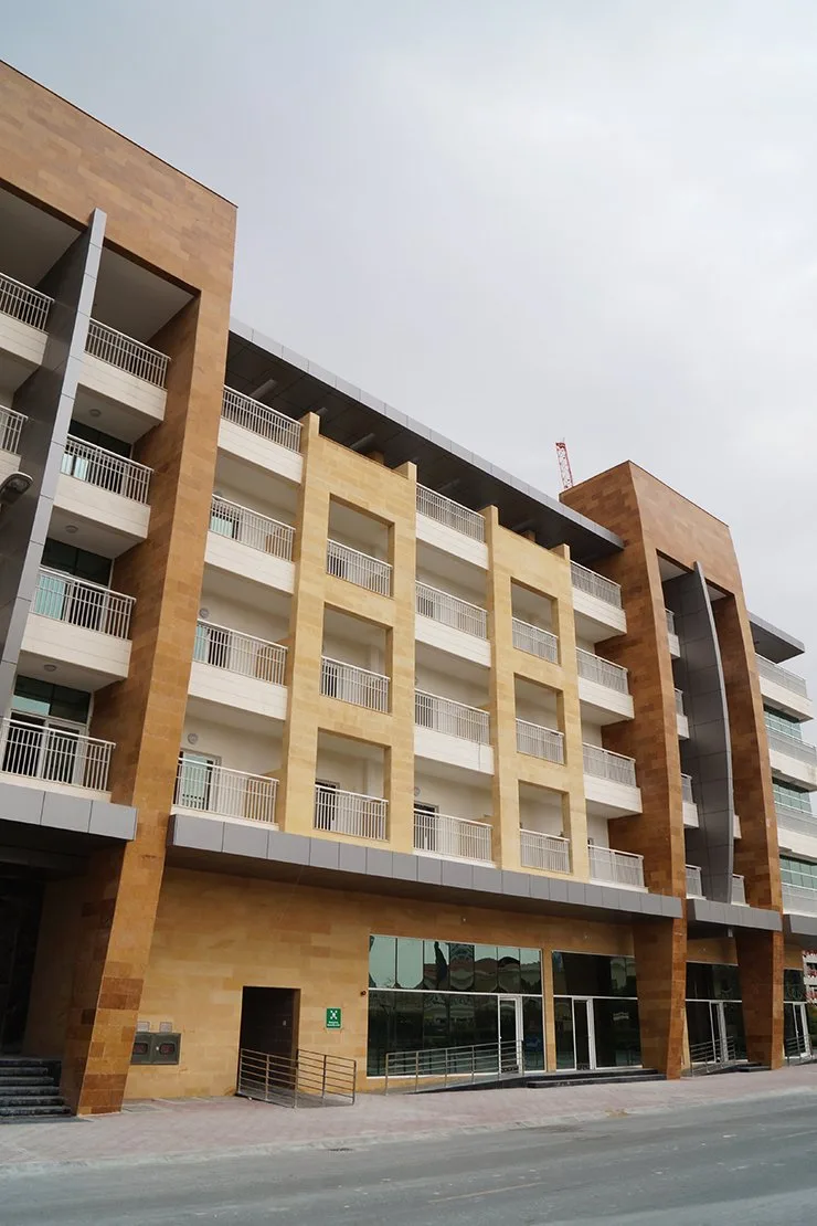 Facade with balconies and ground-floor glazing
