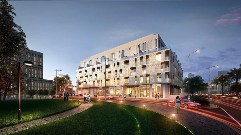 Low-rise block with perforated facade at dusk