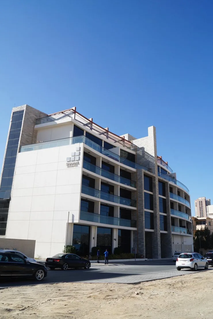 Corner view showing curved balconies and rooftop pergola