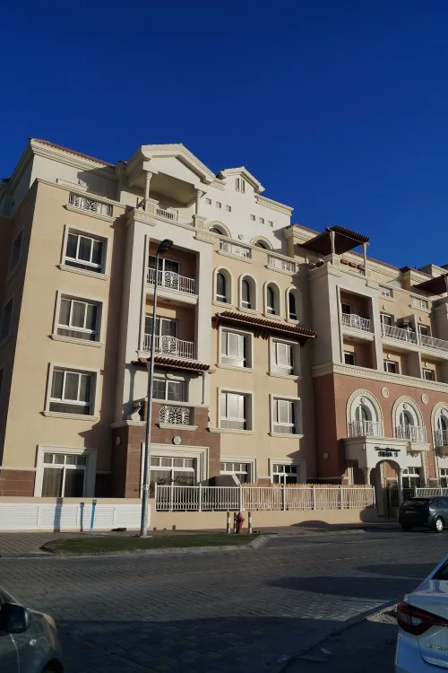 Siena building facade with balconies and arched entrance