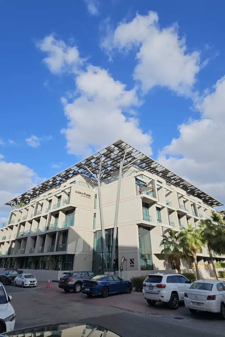 Corner of building with Signature Livings signage