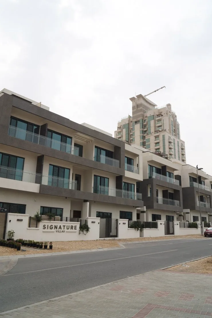 Three-storey villa block with Signature Villas sign