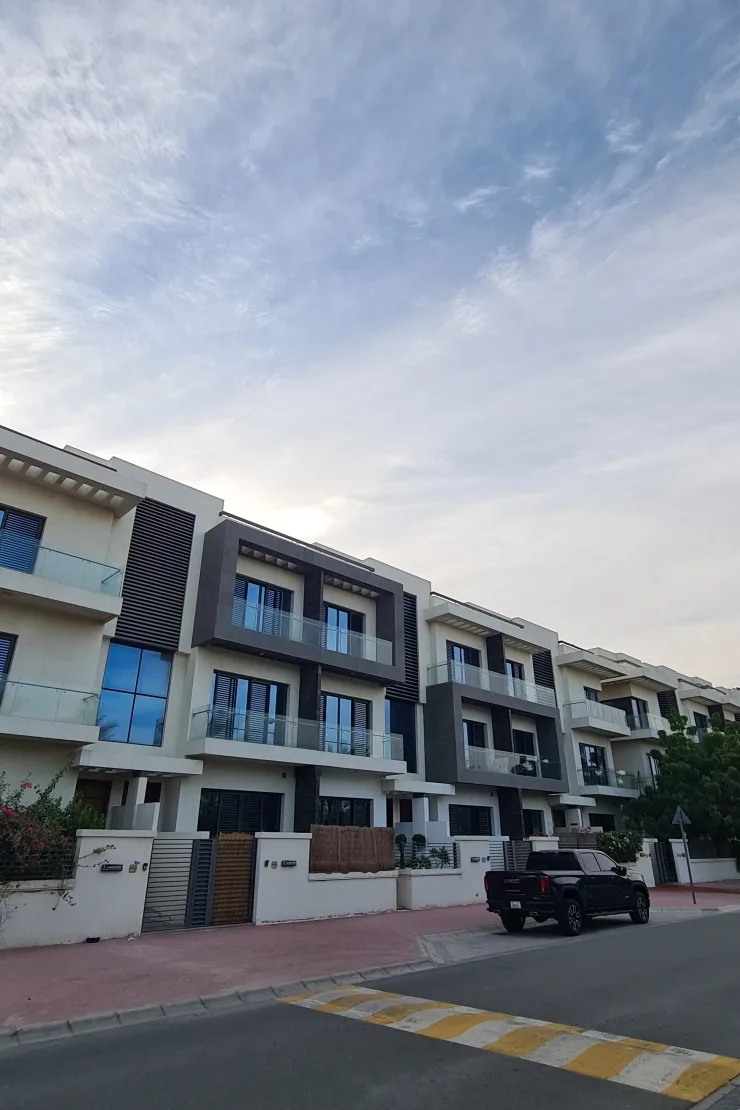 Row of completed three-storey villas from the street
