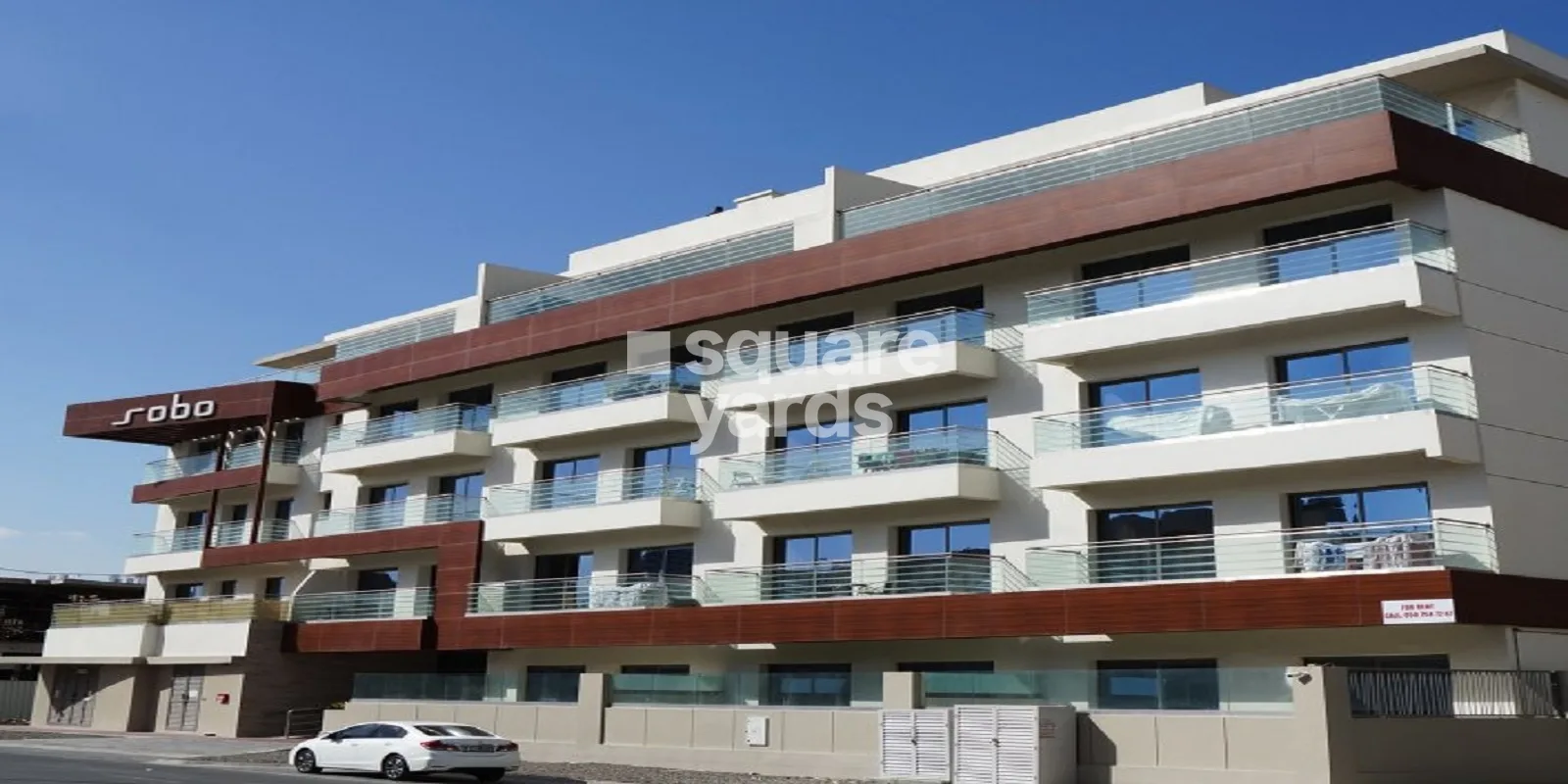 Sobo signage on a low-rise residential building with balconies