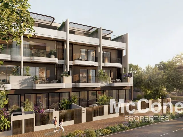 Street-level townhouse facade with balconies and gardens