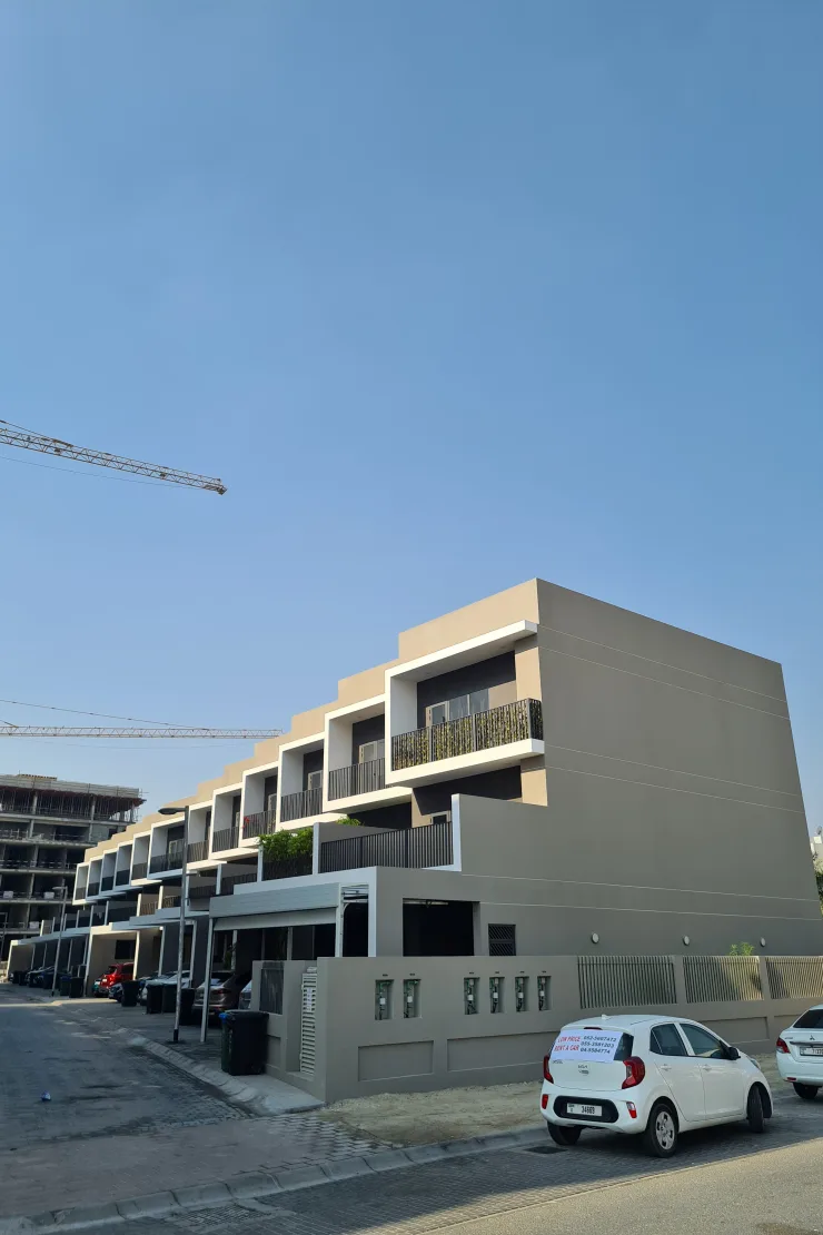 Stepped townhouse block seen from the street corner
