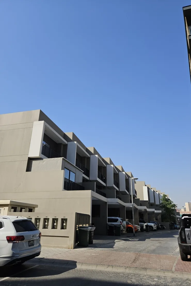 Rear access street with stepped townhouse facades