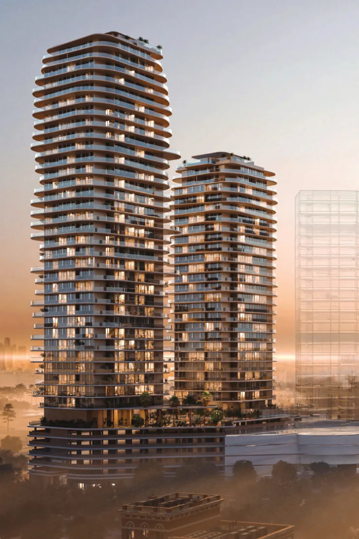Curved-balcony twin towers at dusk, podium visible