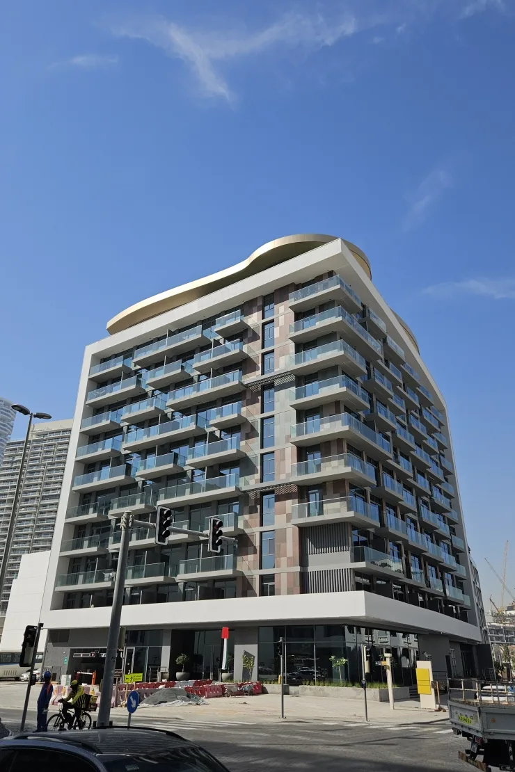 Completed tower with wavy gold crown, street view