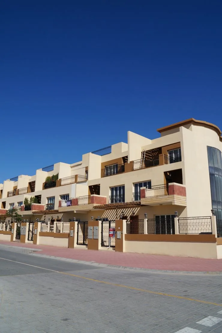 Completed townhouse row, cream and terracotta facade