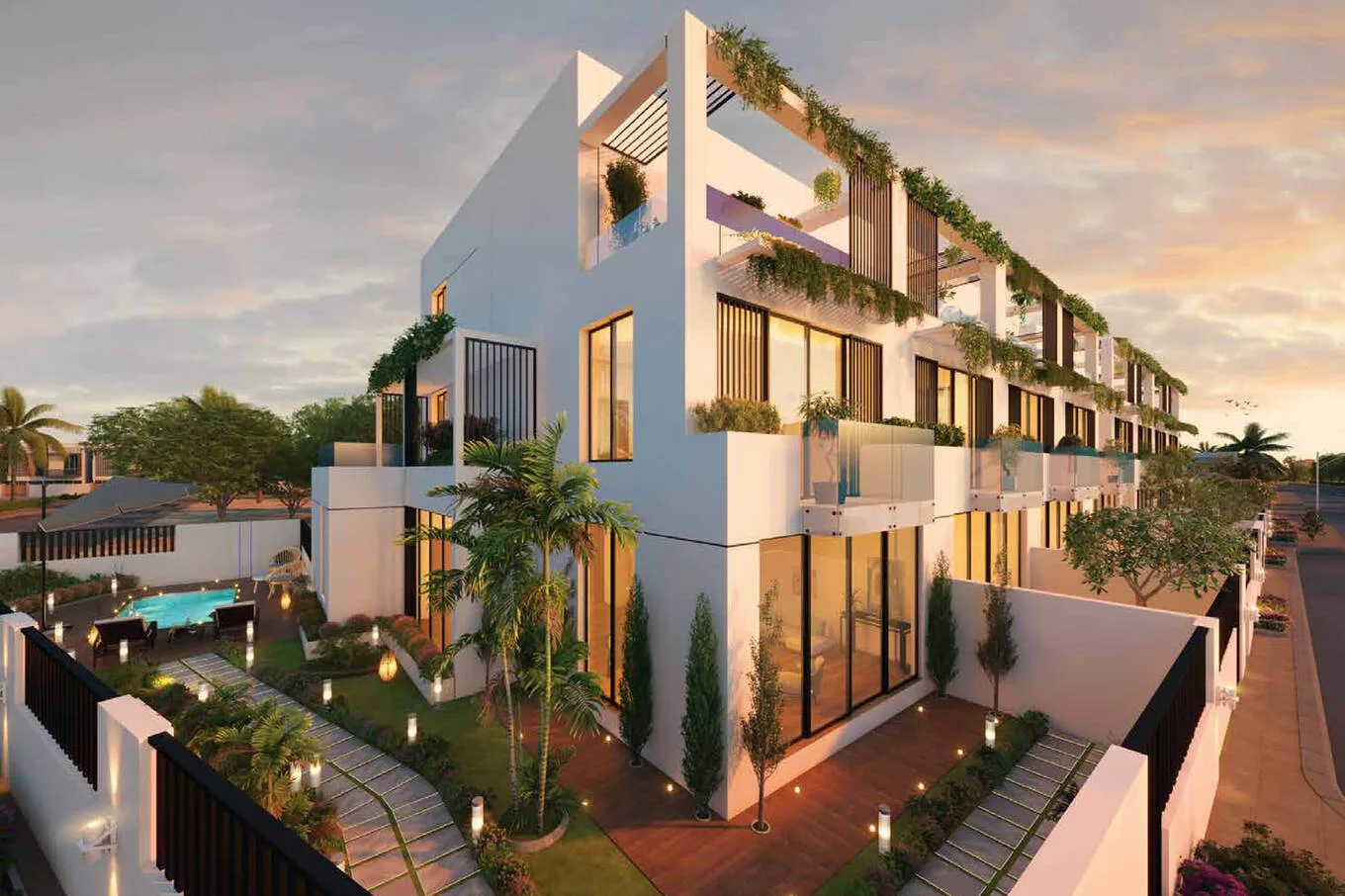 Corner view of white townhouse with pool and garden
