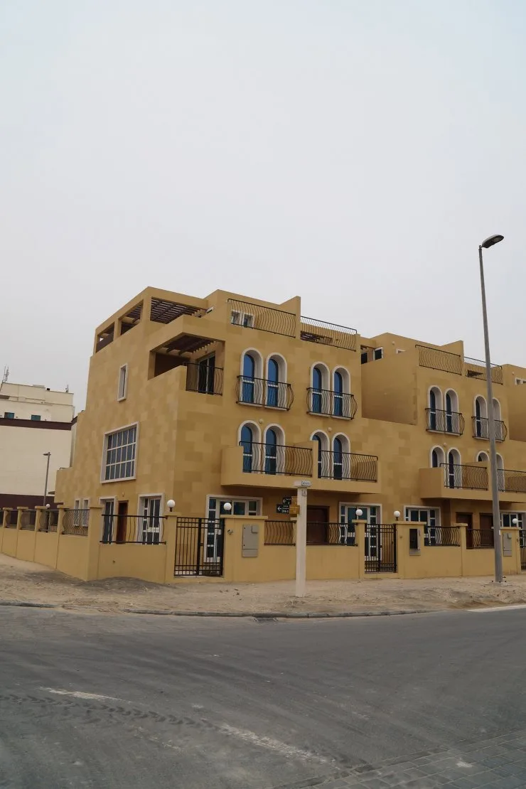 Corner villa with arched windows and balconies