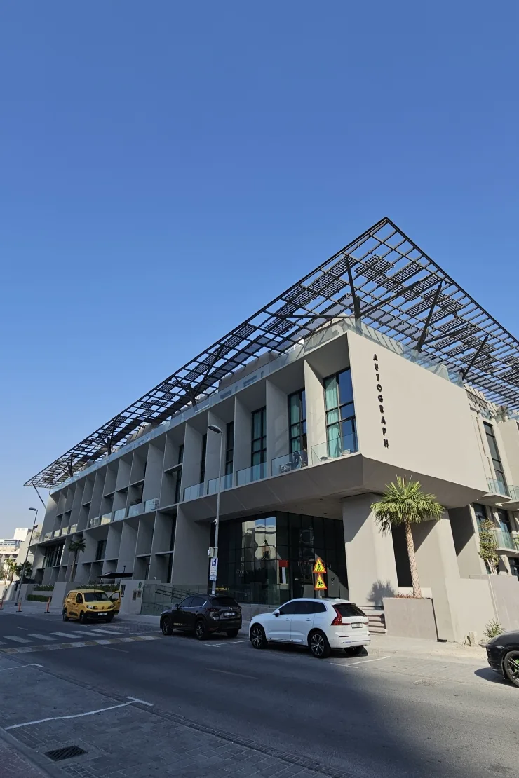 Street view with AUTOGRAPH sign and solar roof