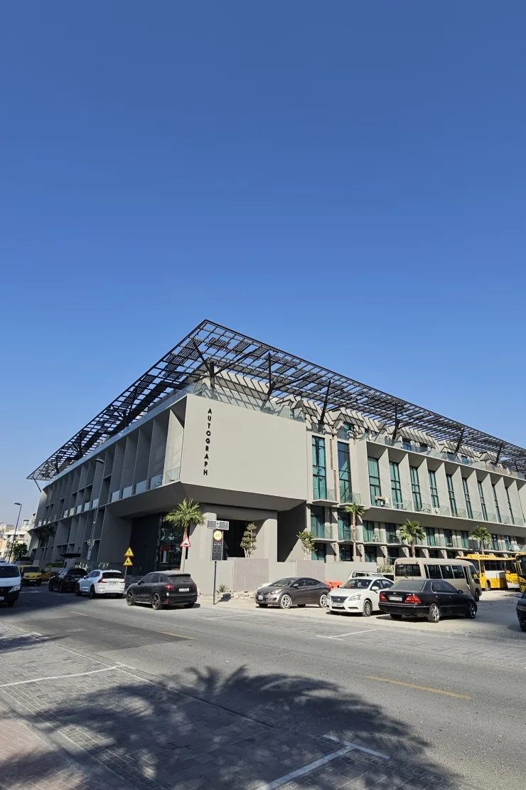 Side facade with AUTOGRAPH sign and solar canopy
